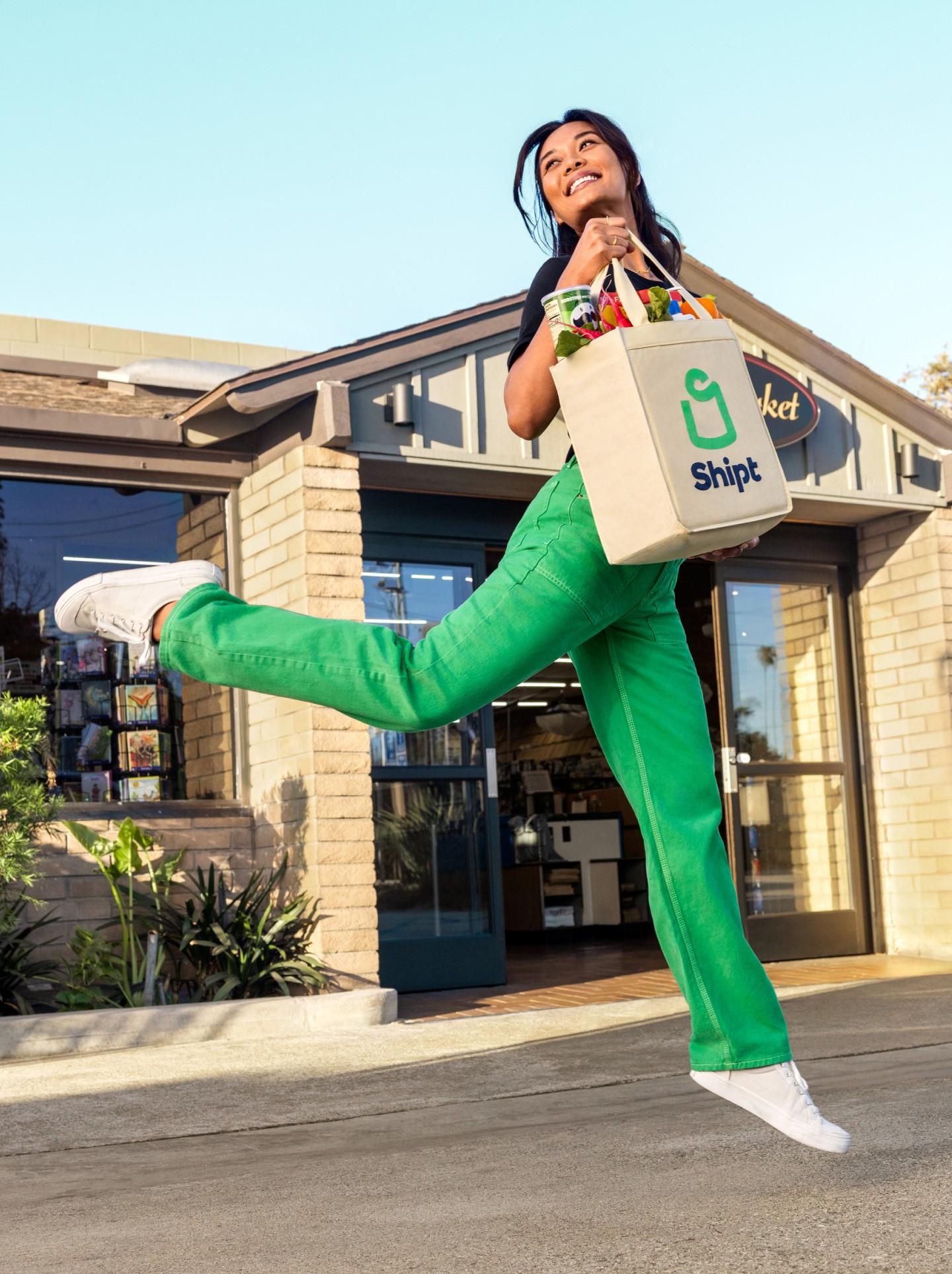 person in green pants jumping with shipt delivery 